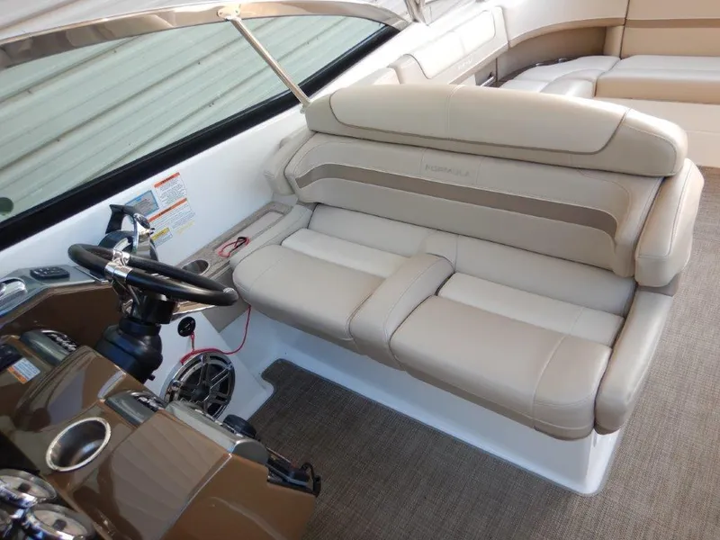 Slide: The Image of 2016 Formula 350 Crossover Bowrider interior with beige seating and steering console. - 14