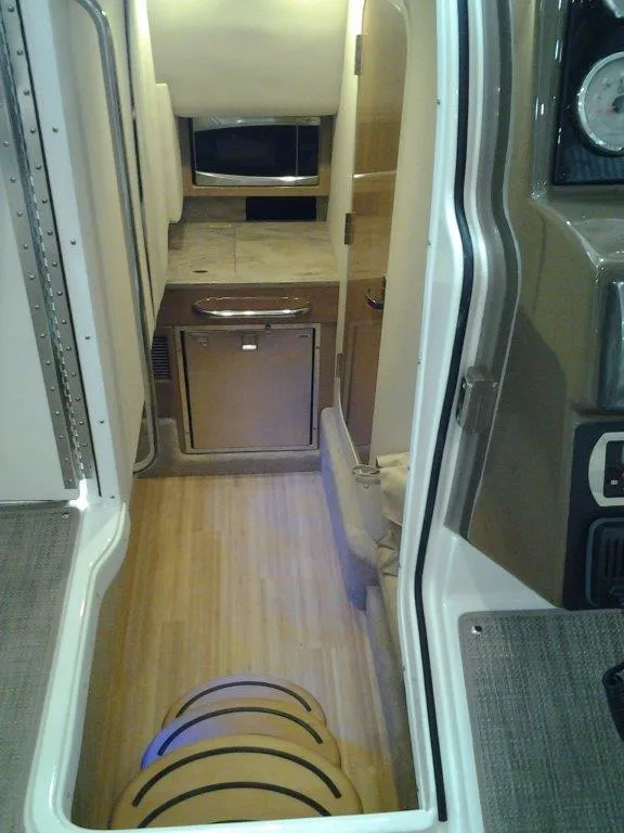Slide: The Image of Interior of 2016 Formula 350 Crossover Bowrider with kitchenette and wood flooring. - 20