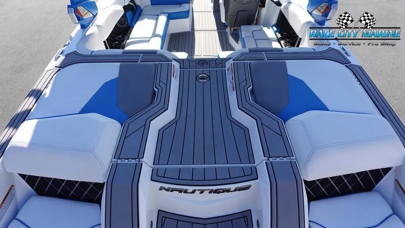Slide: The Image of 2019 Nautique Super Air Nautique GS20 boat interior with blue and white seating. - 13