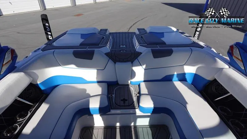 Slide: The Image of 2019 Nautique Super Air Nautique GS20 boat interior with blue and white seating. - 15