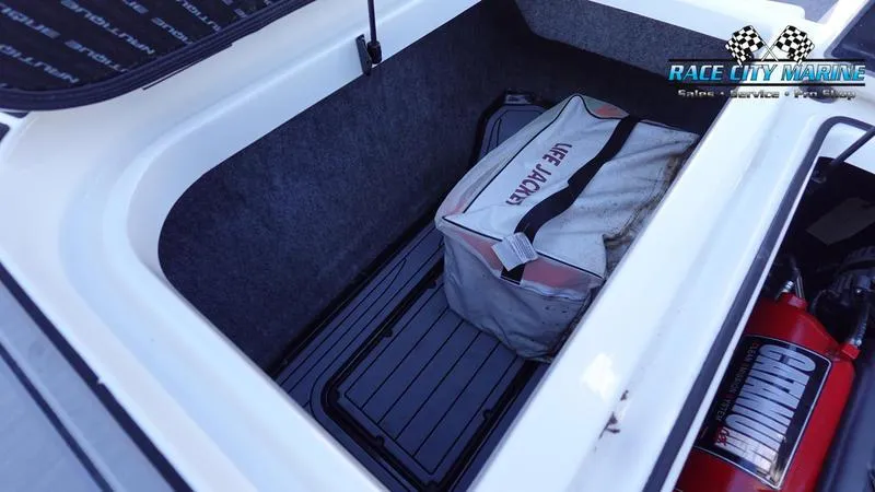 Slide: The Image of 2019 Nautique Super Air Nautique GS20 storage compartment with life jacket bag. - 18