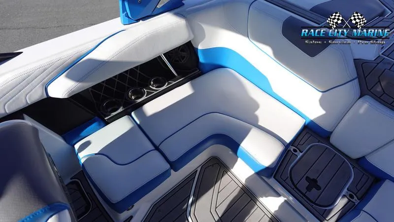 Slide: The Image of 2019 Nautique Super Air Nautique GS20 interior with blue and white seating and cup holders. - 20