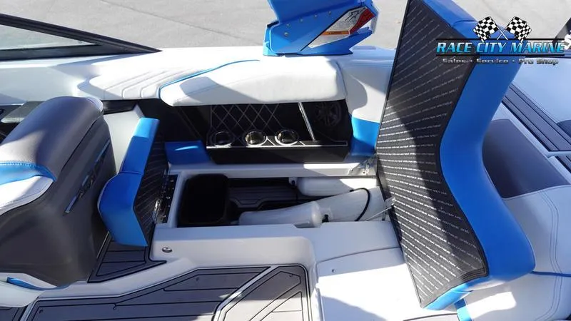 Slide: The Image of 2019 Nautique Super Air Nautique GS20 interior with blue accents and storage compartments. - 22