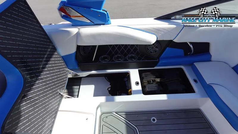 Slide: The Image of 2019 Nautique Super Air Nautique GS20 interior with blue and white seating and storage compartments. - 23