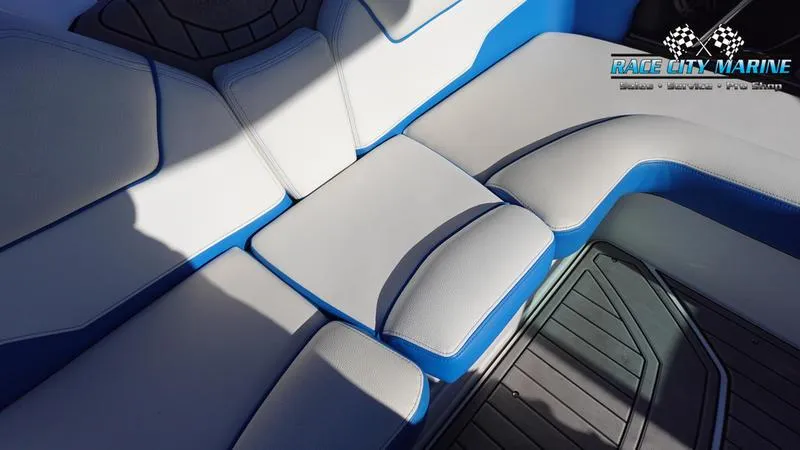 Slide: The Image of 2019 Nautique Super Air Nautique GS20 interior seating with blue and white upholstery. - 25