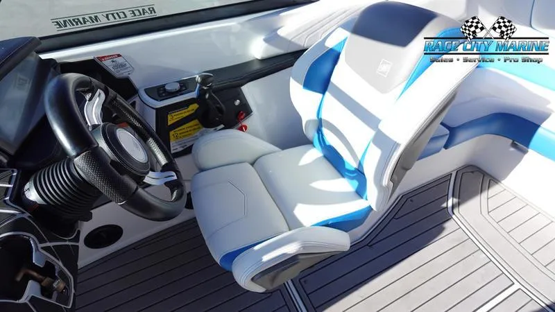 Slide: The Image of 2019 Nautique Super Air Nautique GS20 interior with steering wheel and blue-accented seat. - 30