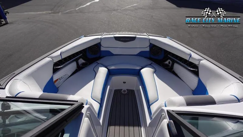 Slide: The Image of 2019 Nautique Super Air Nautique GS20 boat interior with white and blue seating. - 38