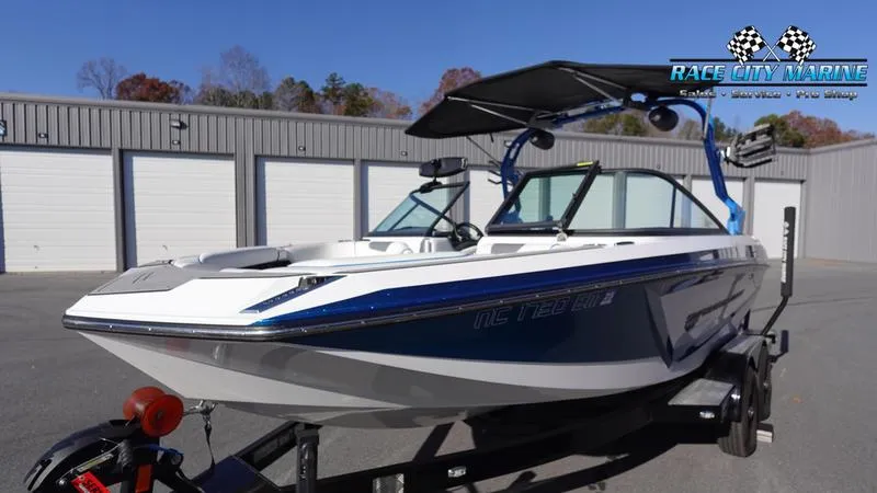 Slide: The Image of 2019 Nautique Super Air Nautique GS20 boat on trailer, parked outside storage units. - 6