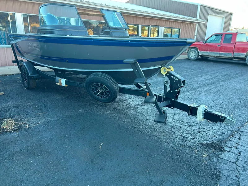 Slide: The Image of 2025 Lund 1875 Impact XS boat on trailer in parking lot. - 3