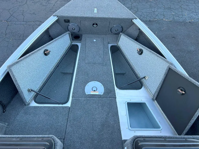 Slide: The Image of 2025 Lund 1875 Impact XS boat interior with open storage compartments. - 4
