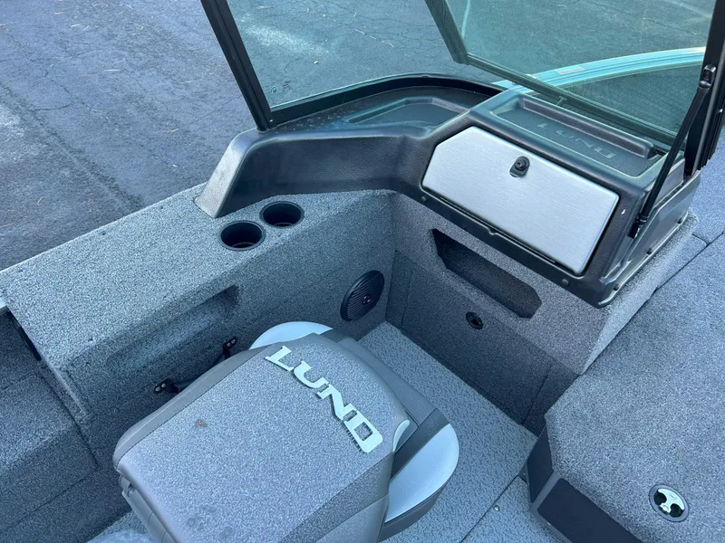 Slide: The Image of 2025 Lund 1875 Impact XS boat interior with seating and storage compartments. - 7