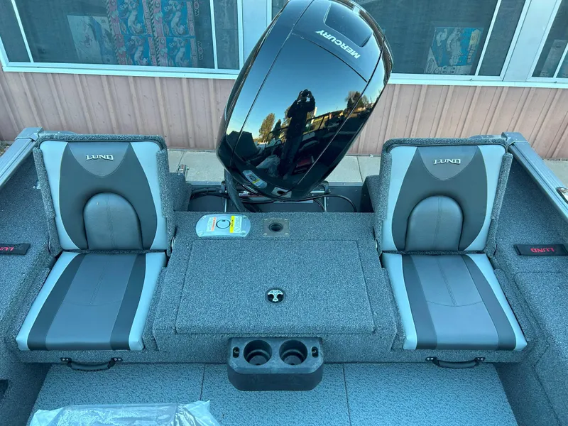 Slide: The Image of 2025 Lund 1875 Impact XS boat interior with dual seats and Mercury engine. - 8