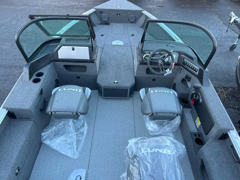 Slide: The Image of 2025 Lund 1875 Impact XS boat interior with seating and steering console. - 9