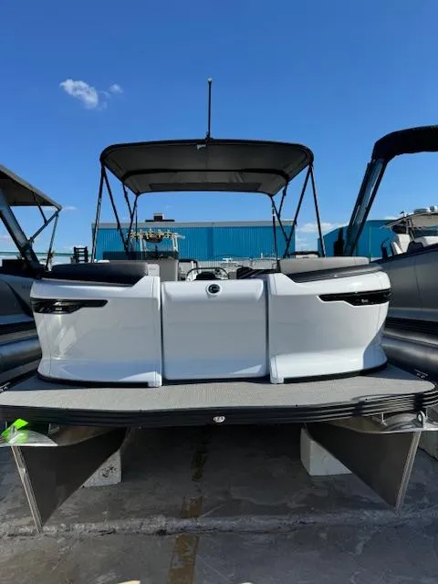 The Image of 2025 Manitou 22' Cruise Bench Twin Tube pontoon boat, docked under clear blue sky. - 0