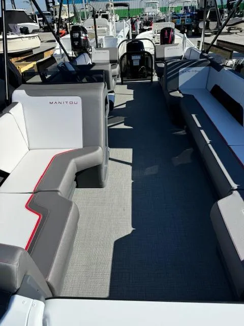 Slide: The Image of 2025 Manitou 22' Cruise Bench Twin Tube pontoon boat interior with gray seating. - 2
