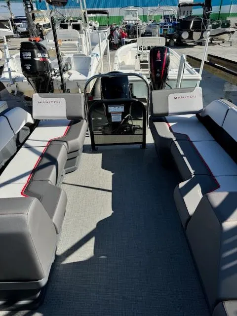 Slide: The Image of 2025 Manitou 22' Cruise Bench Twin Tube pontoon boat interior with seating and controls. - 3