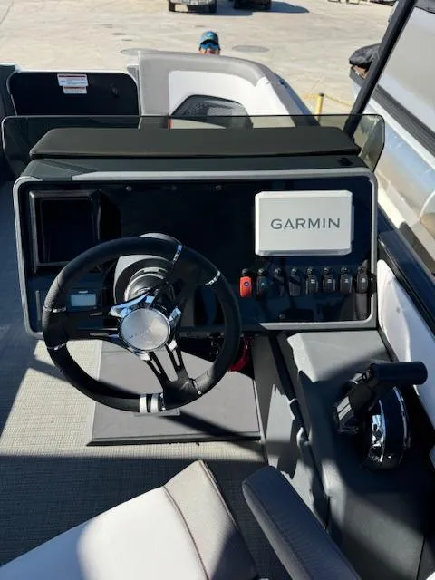 Slide: The Image of 2025 Manitou 22' Cruise Bench Twin Tube boat dashboard with Garmin navigation system. - 6