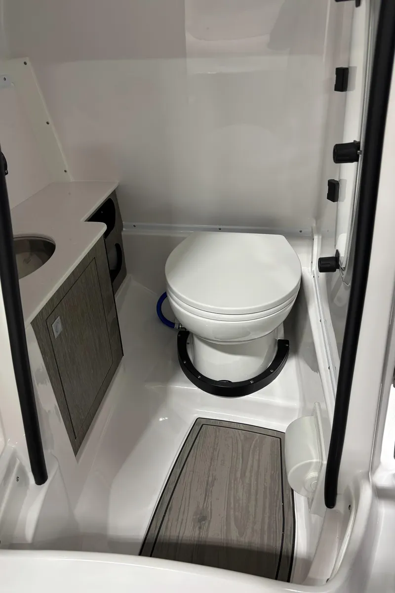 Slide: The Image of Compact bathroom in 2025 Monterey M-65 boat with toilet and sink. - 5
