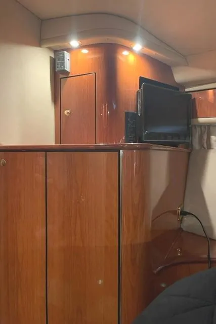 Slide: The Image of Interior of 2001 Sea Ray Sundancer 540 yacht with wood paneling and built-in TV. - 14