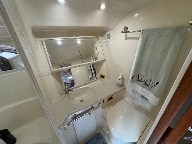 Slide: The Image of Bathroom interior of 2001 Sea Ray Sundancer 540 yacht, featuring sink, mirror, and towel. - 17