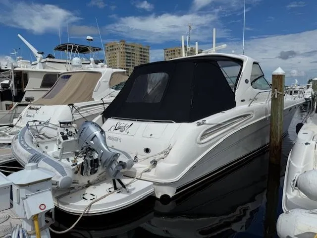 Slide: The Image of 2001 Sea Ray Sundancer 540 yacht docked at marina under blue sky. - 2
