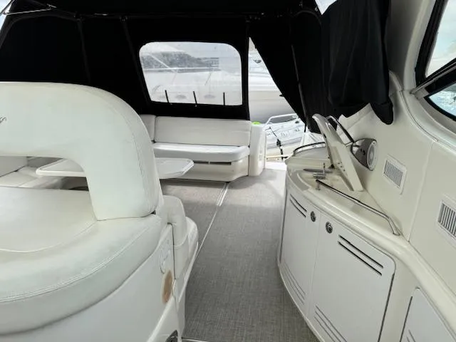 Slide: The Image of Interior of 2001 Sea Ray Sundancer 540 yacht with white seating and helm station. - 27