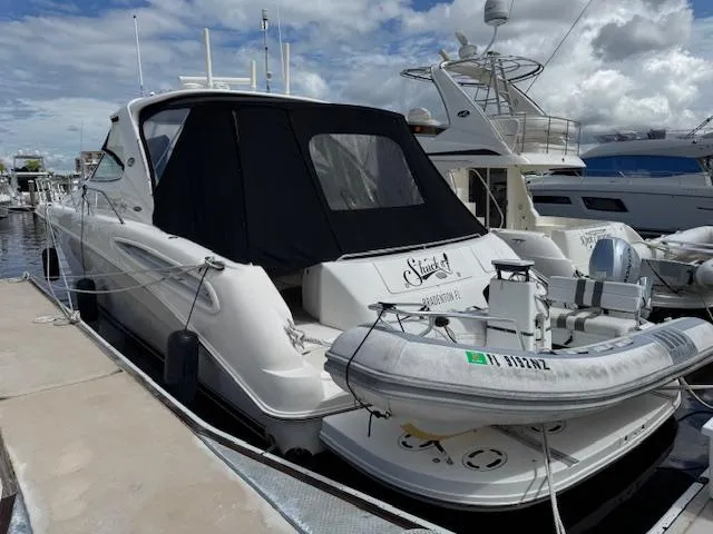 Slide: The Image of 2001 Sea Ray Sundancer 540 yacht docked with inflatable boat on stern. - 3