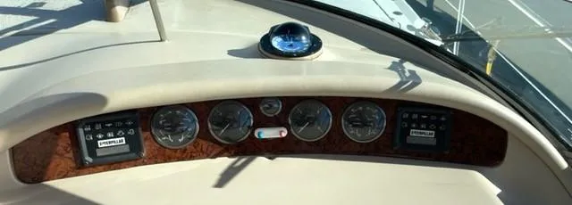 Slide: The Image of Dashboard of a 2001 Sea Ray Sundancer 540 yacht with gauges and compass. - 32