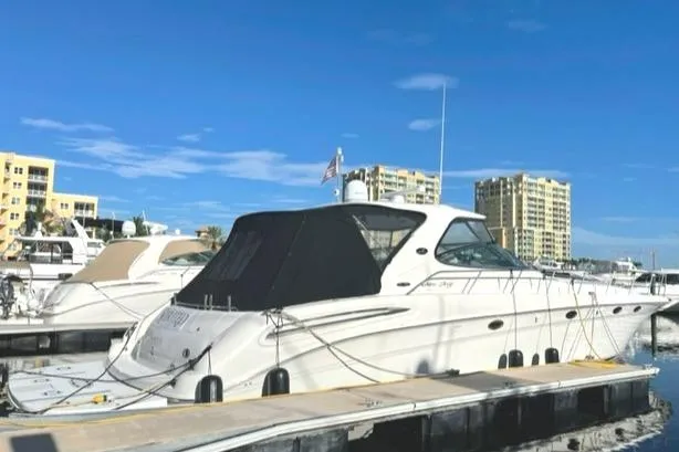 Slide: The Image of 2001 Sea Ray Sundancer 540 yacht docked at marina under clear blue sky. - 6