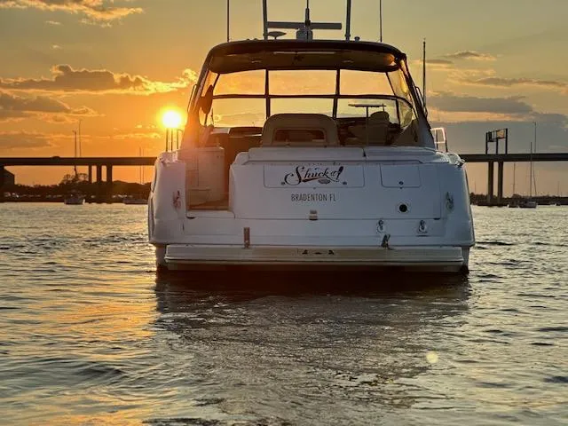 Slide: The Image of 2001 Sea Ray Sundancer 540 yacht at sunset, near a bridge on calm water. - 7