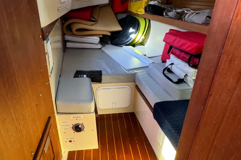 Slide: The Image of Cozy cabin interior of a 1989 Catalina 42 sailboat with storage and seating. - 10