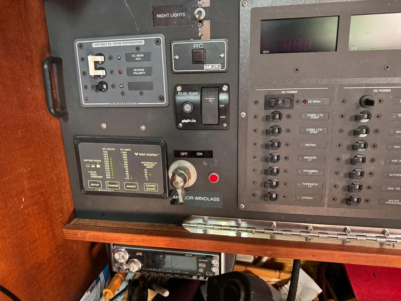 Slide: The Image of Control panel of a 1989 Catalina 42 sailboat, featuring switches and gauges. - 13