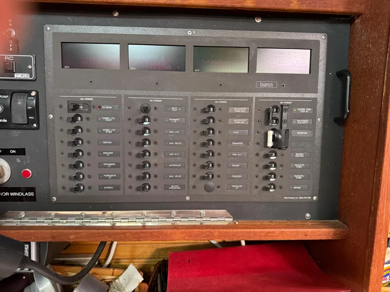 Slide: The Image of Electrical control panel on a 1989 Catalina 42 sailboat, featuring multiple switches and displays. - 14