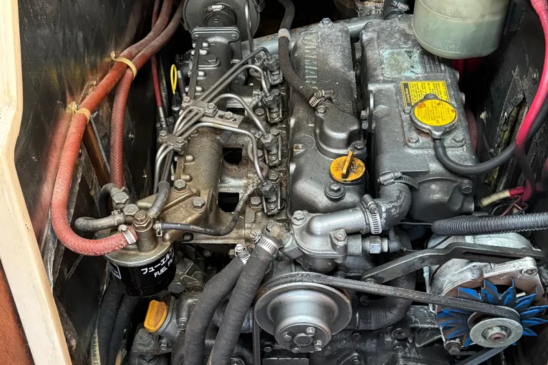 Slide: The Image of Engine compartment of a 1989 Catalina 42 sailboat, showing detailed mechanical components. - 15