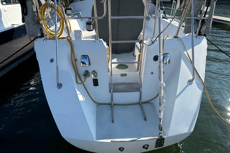 Slide: The Image of 1989 Catalina 42 sailboat stern view with docked marina setting. - 18