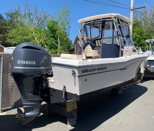 Slide: The Image of 2014 Grady-White Seafarer 226 boat with Yamaha outboard motor, parked outdoors. - 2