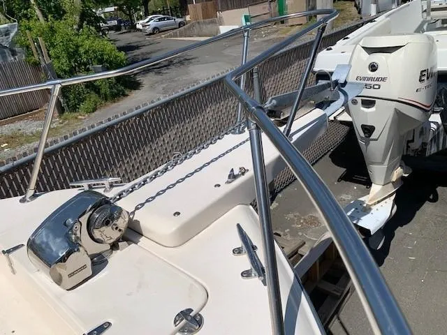 Slide: The Image of 2014 Grady-White Seafarer 226 boat with Evinrude 150 engine, docked outdoors. - 7