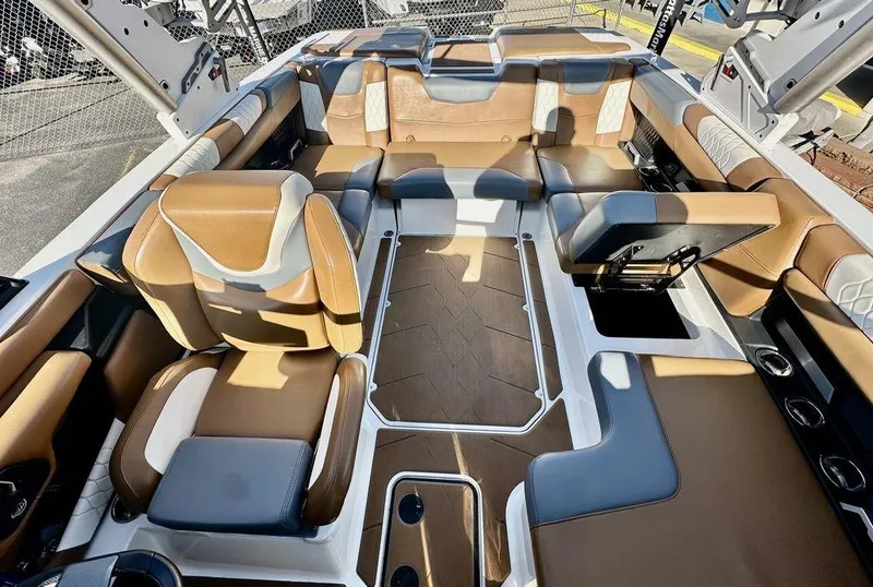 Slide: The Image of 2023 Malibu M220 boat interior with luxurious tan and gray seating. - 10
