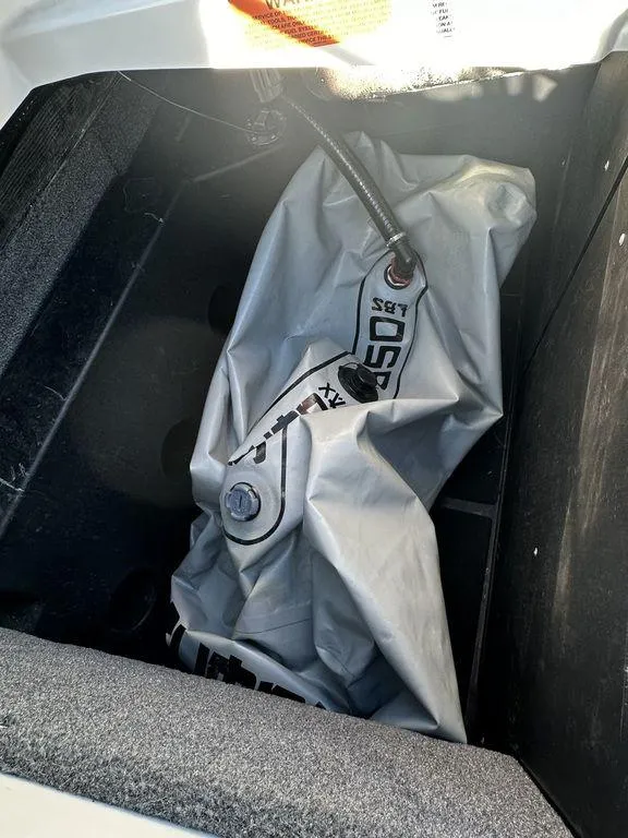 Slide: The Image of 2023 Malibu M220 ballast bag in storage compartment. - 18