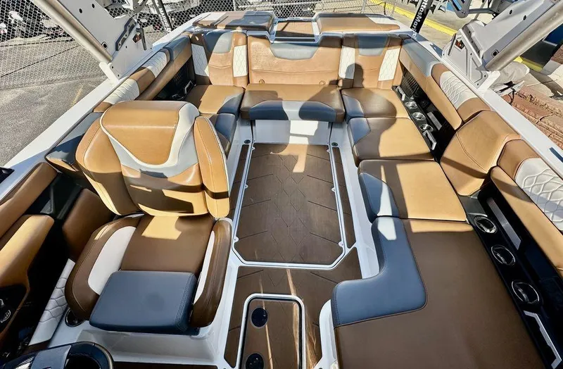 Slide: The Image of Luxurious interior of 2023 Malibu M220 boat with tan and gray seating. - 9