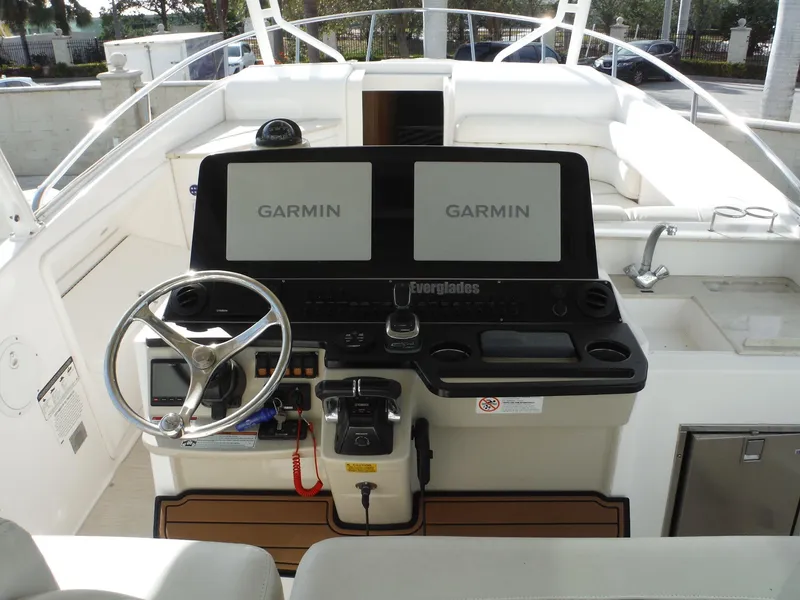 Slide: The Image of 2017 Everglades 360LXC boat helm with dual Garmin displays and steering wheel. - 20