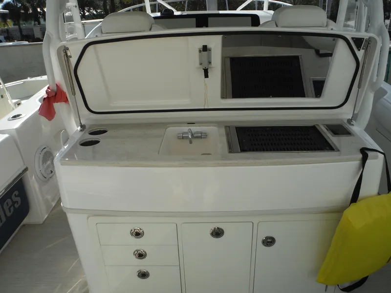 Slide: The Image of 2017 Everglades 360LXC boat interior with sink and storage compartments. - 22