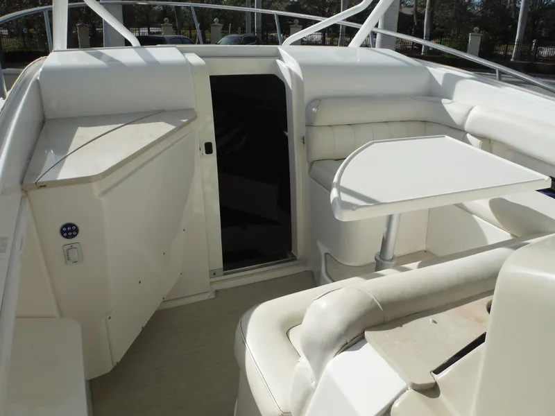 Slide: The Image of 2017 Everglades 360LXC boat interior with white seating and table. - 23