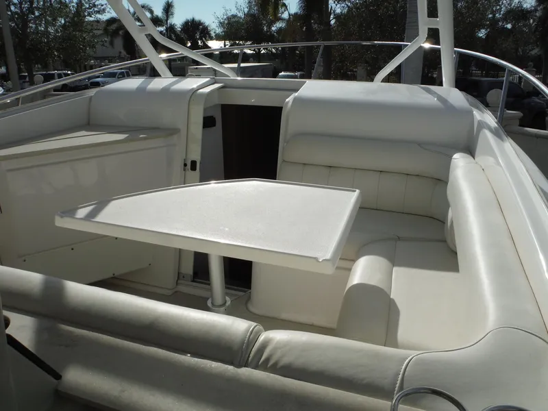 Slide: The Image of 2017 Everglades 360LXC boat interior with white seating and table. - 25