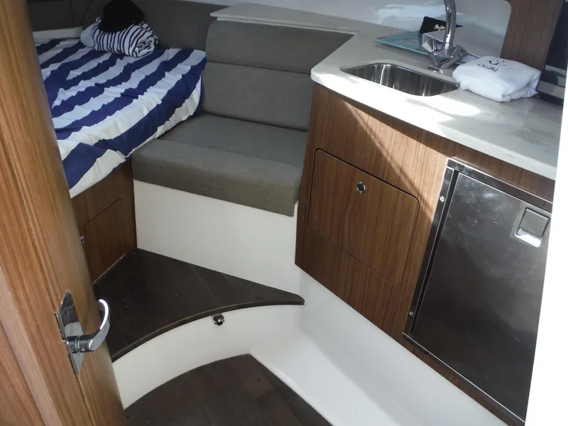 Slide: The Image of 2017 Everglades 360LXC cabin interior with bed, sink, and wood cabinetry. - 31