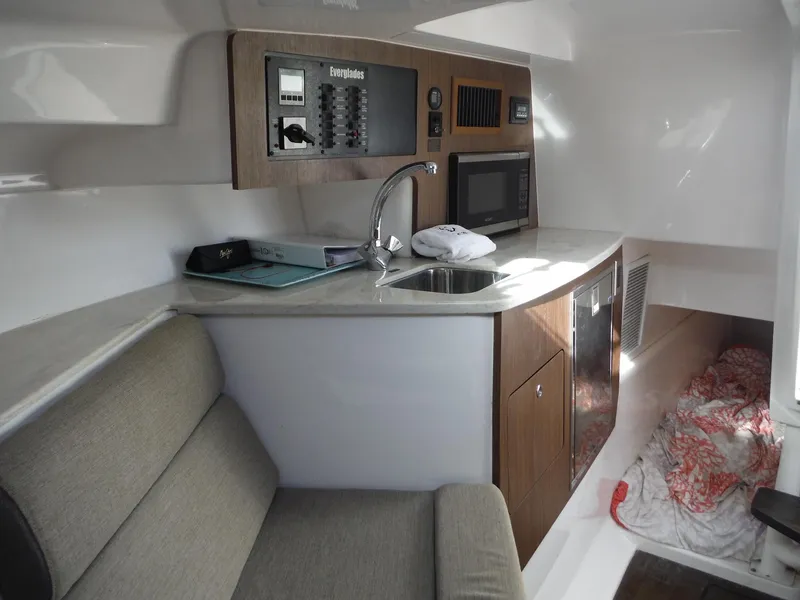 Slide: The Image of Interior of 2017 Everglades 360LXC boat with kitchenette and seating area. - 33