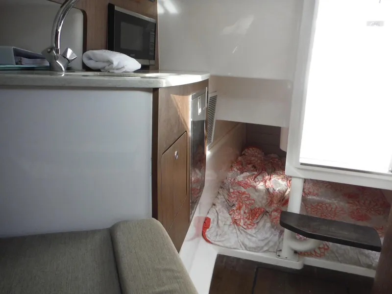 Slide: The Image of Interior of 2017 Everglades 360LXC boat with kitchenette and cozy sleeping area. - 34