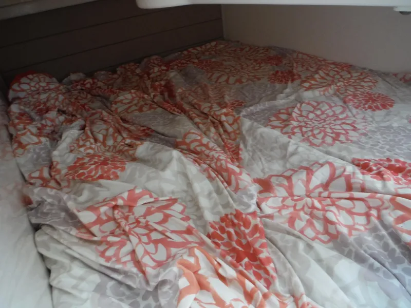 Slide: The Image of Floral-patterned bedding inside a 2017 Everglades 360LXC cabin. - 35