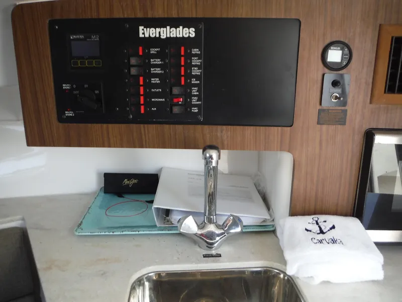Slide: The Image of Control panel and sink area in 2017 Everglades 360LXC boat interior. - 36