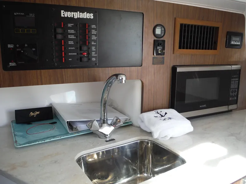 Slide: The Image of 2017 Everglades 360LXC boat interior with sink, microwave, and control panel. - 37